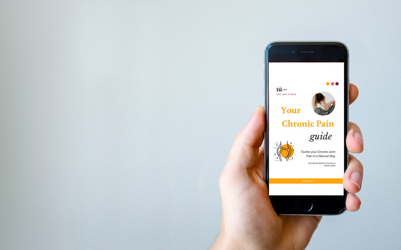 Phone displaying the free PDF online chronic pain guide by Carlyle Jenkins and iüLabs