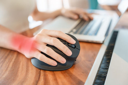 red inflamed arthritic hand holding a computer mouse