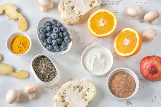 ingredients on a white table, ginger, blueberries, cauliflower, pomegranate, mushrooms, polyphenols