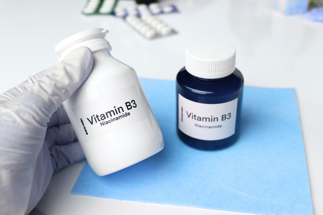 bottle of vitamin B3 in a lab with gloves