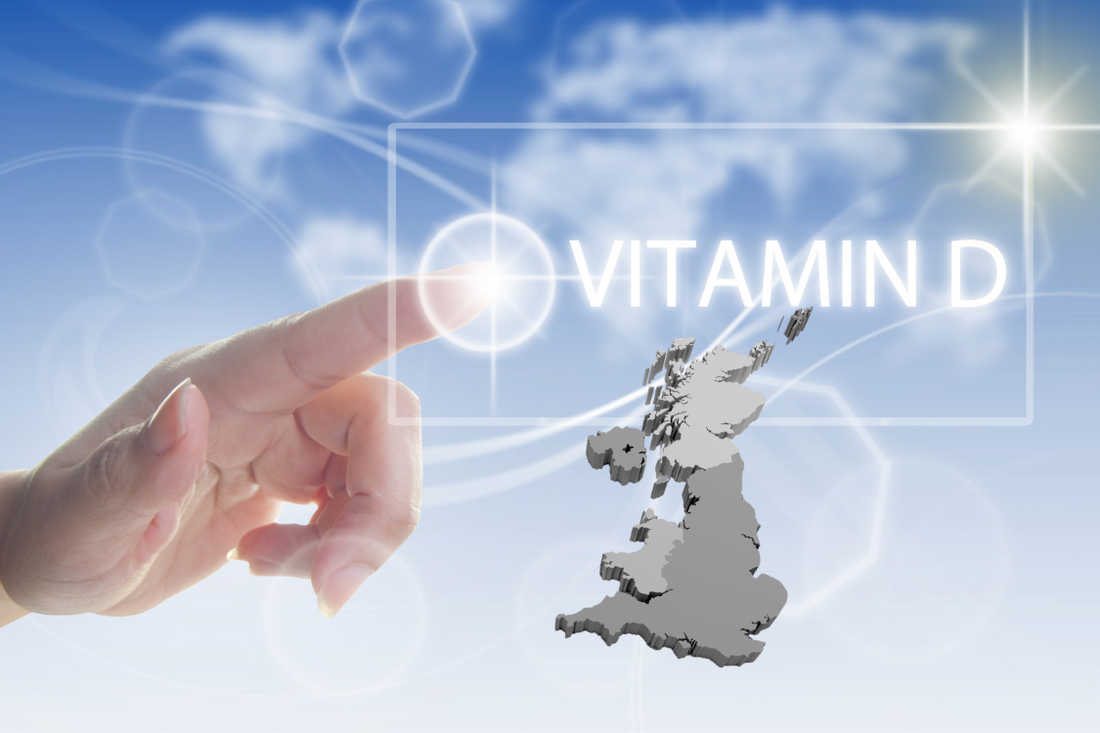 finger on the pulse of vitamin D with a sunshine blue skies and a map of the United Kingdom to show vitamin D levels in the UK