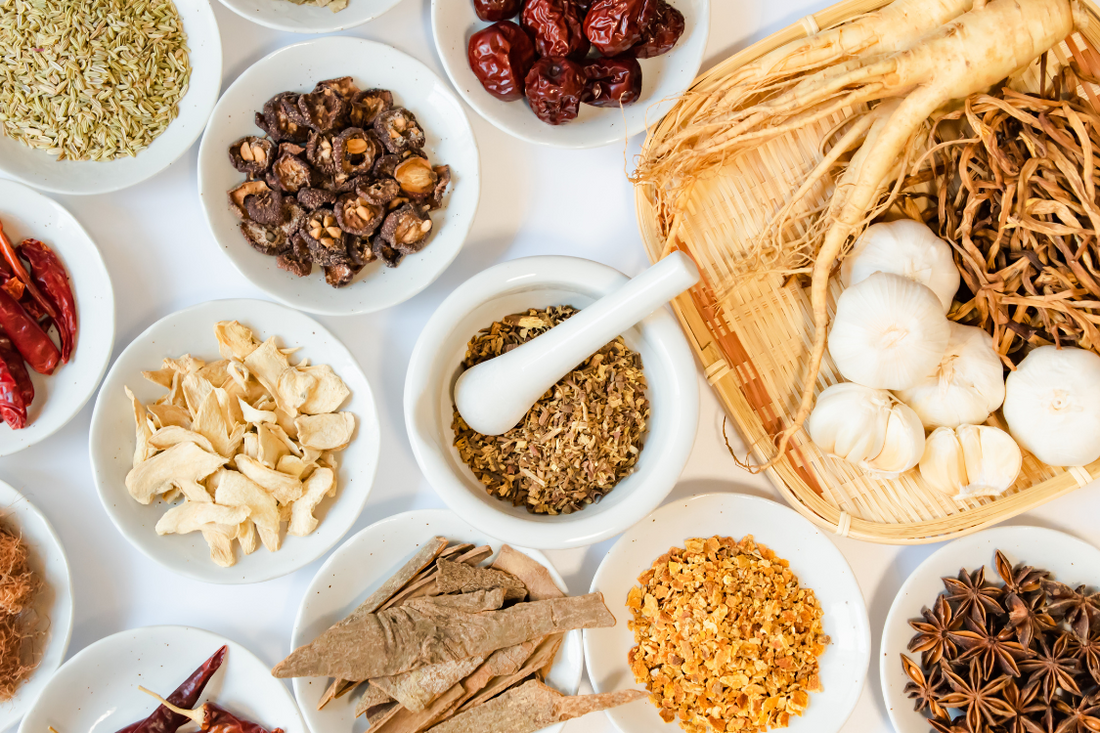 different types of adaptogens on a white table, mushrooms, ginger, ashwaghanda, star anise